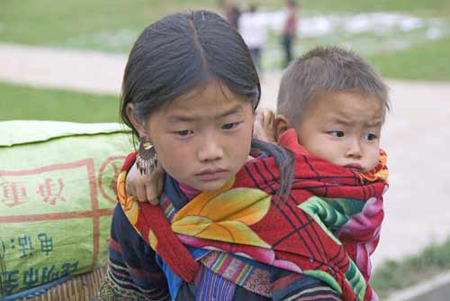 sister carrying brother-AsiaPhotoStock