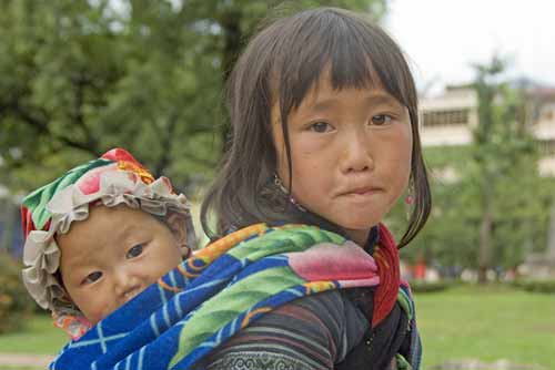 sister carrying sibling-AsiaPhotoStock