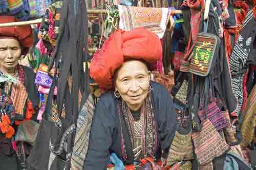 red dzao elder at stall-AsiaPhotoStock