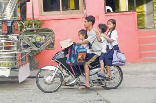 four on a bike-AsiaPhotoStock