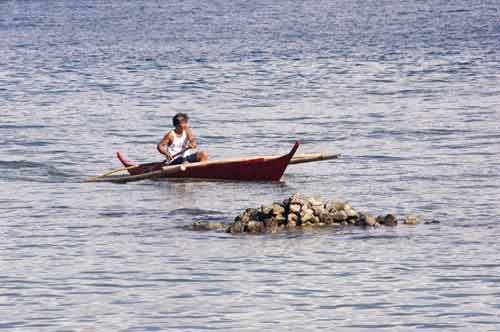 boat near rocks-AsiaPhotoStock