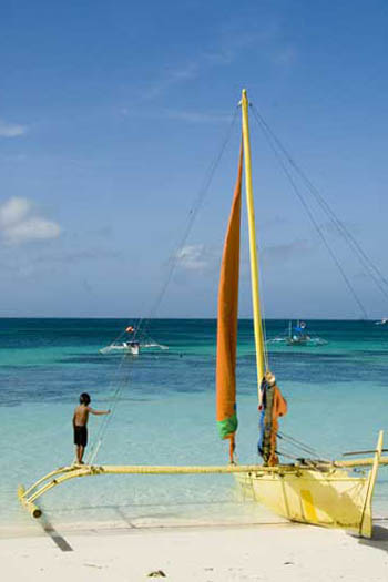 boy on outrigger-AsiaPhotoStock