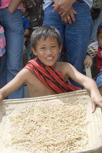 boy tossing rice-AsiaPhotoStock