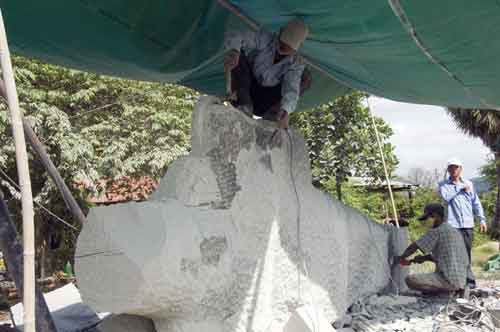 carving a buddha-AsiaPhotoStock