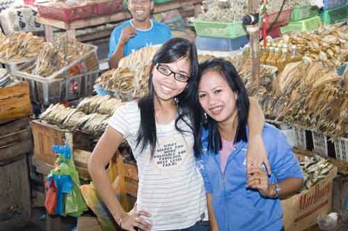 girls by dried fish-AsiaPhotoStock