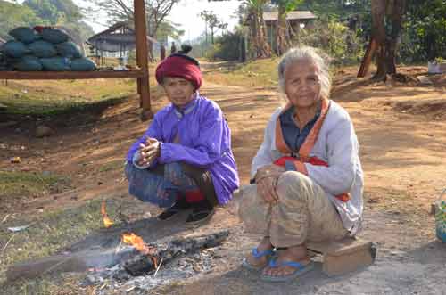 sitting round fire-AsiaPhotoStock