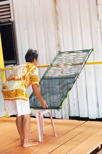 woman drying fish-AsiaPhotoStock