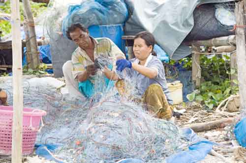 mending fishing nets-AsiaPhotoStock