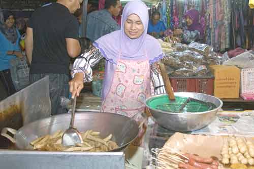 frying food in big wok-AsiaPhotoStock