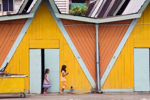 girls by yellow wall-AsiaPhotoStock