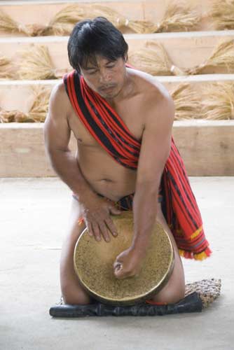 man playing a gong-AsiaPhotoStock
