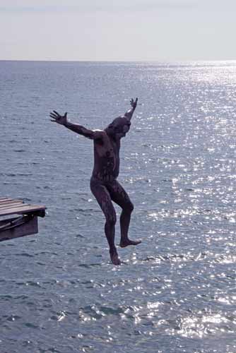 jumping from jetty-AsiaPhotoStock