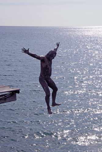 jumping from jetty-AsiaPhotoStock