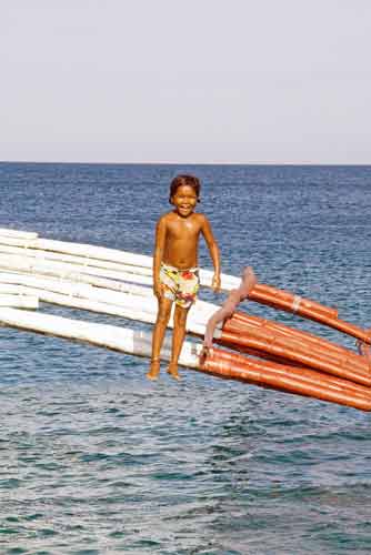 boy jumps off boat-AsiaPhotoStock