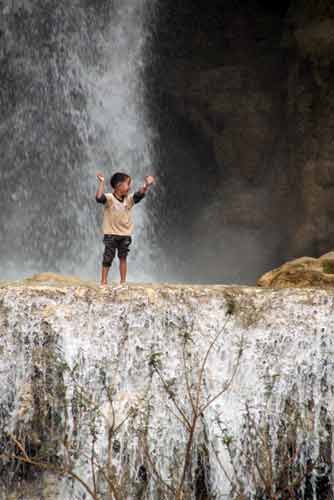 kid at falls-AsiaPhotoStock