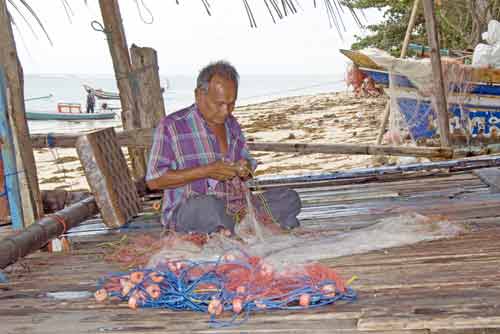 man mending nets-AsiaPhotoStock