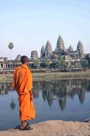 monk looking angkor wat-AsiaPhotoStock