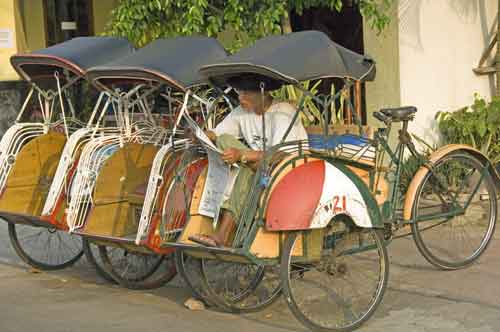 reading becak man-AsiaPhotoStock