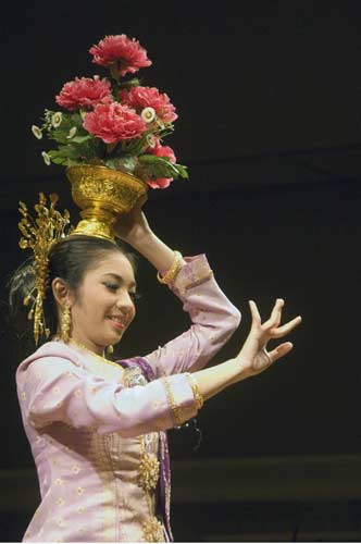 red flowers on head-AsiaPhotoStock