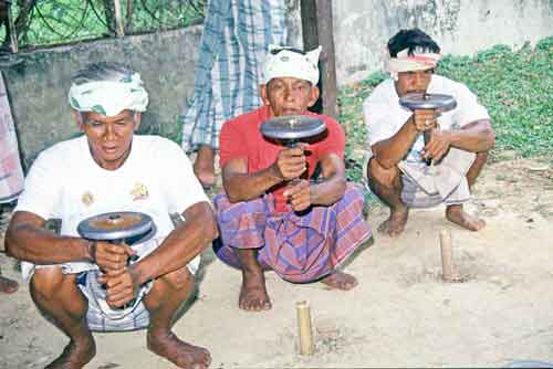 malay men spinning tops-AsiaPhotoStock