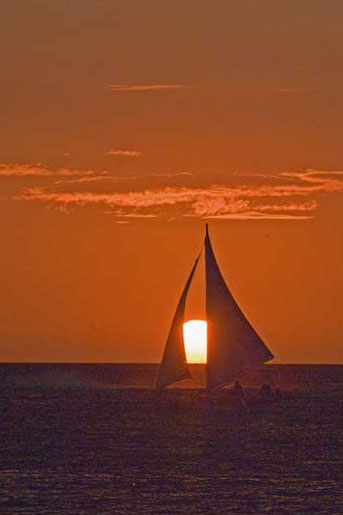 sun setting between sails-AsiaPhotoStock