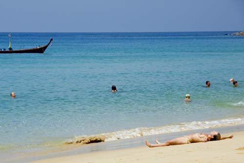 topless lady sunbathes-AsiaPhotoStock