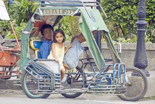 girl in tricycle-AsiaPhotoStock
