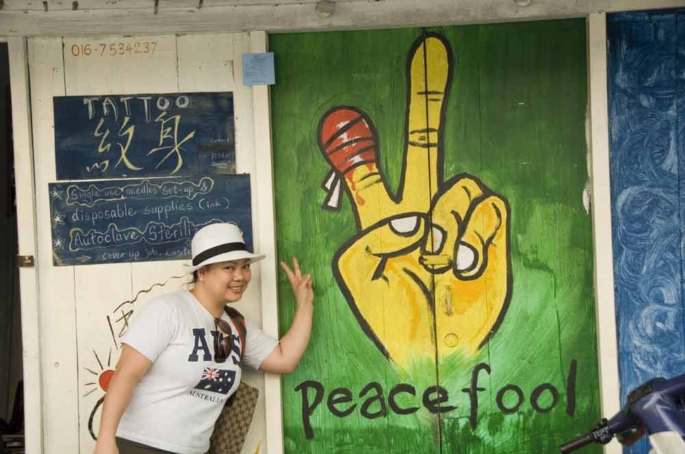 tourists pose for peace-AsiaPhotoStock