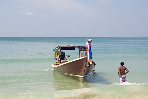 boatman wades to boat-AsiaPhotoStock